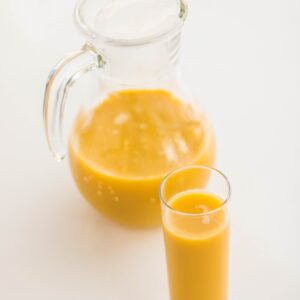 Delicious and refreshing orange juice served in a glass and pitcher, perfect for a healthy start to your day.
